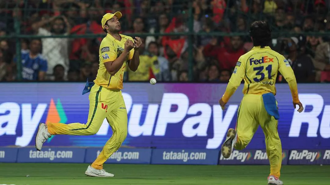 Two yellow-clad IPL fielders track a descending ball during a catching chance, representing the gap between spectacular athleticism and basic catch execution in GNN fielding analysis
